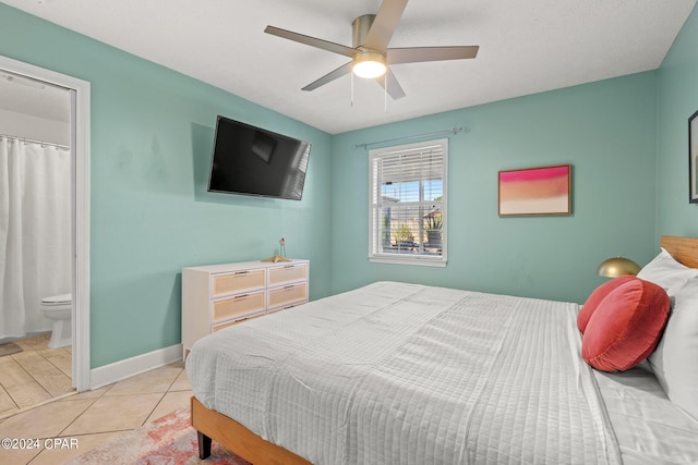 tiled bedroom featuring connected bathroom and ceiling fan