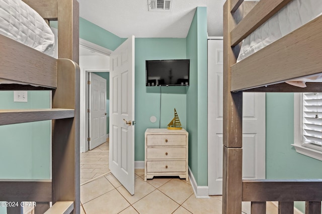 bedroom with light tile patterned flooring