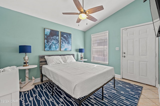 bedroom featuring ceiling fan, light tile patterned flooring, and lofted ceiling