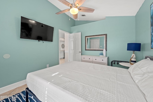 bedroom featuring ceiling fan, light tile patterned flooring, and vaulted ceiling