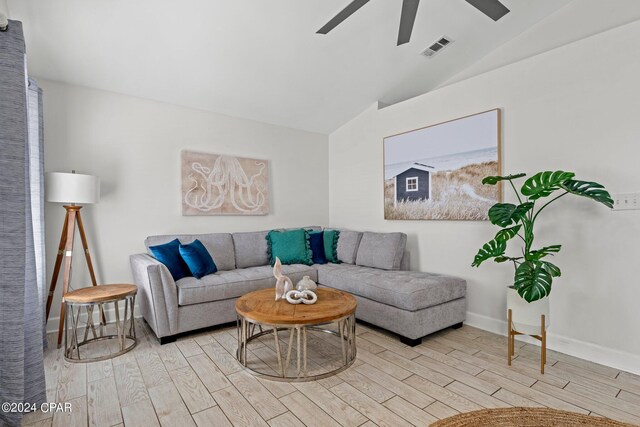 living room featuring light hardwood / wood-style flooring and lofted ceiling