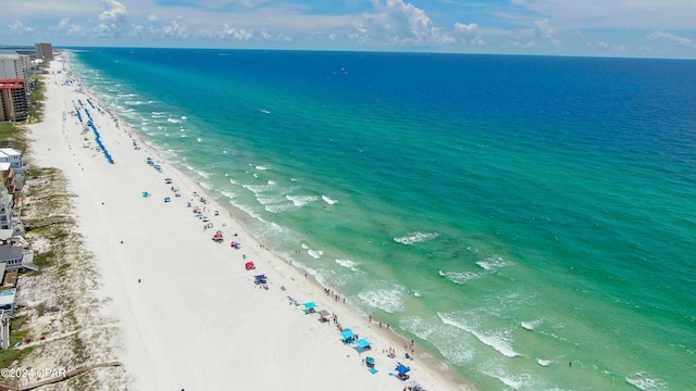 aerial view with a water view and a beach view