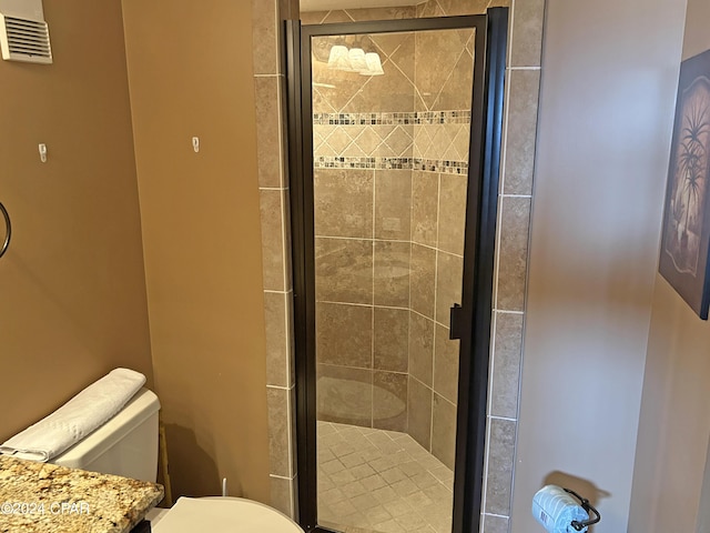 bathroom featuring walk in shower and toilet