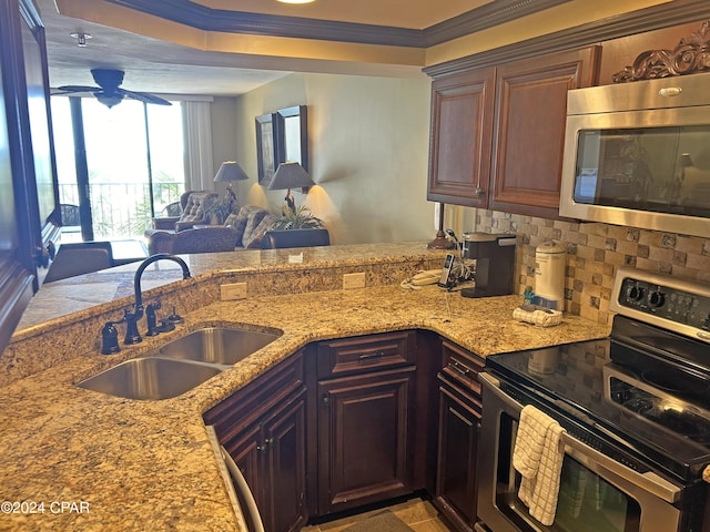 kitchen featuring dark brown cabinetry, sink, appliances with stainless steel finishes, ornamental molding, and decorative backsplash