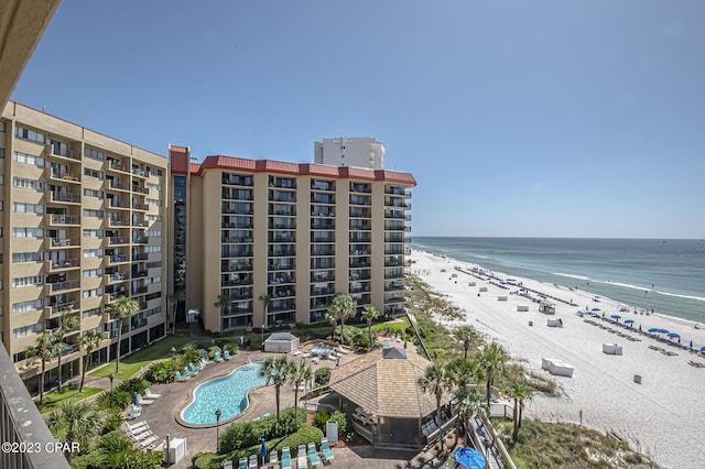 view of building exterior featuring a view of the beach and a water view