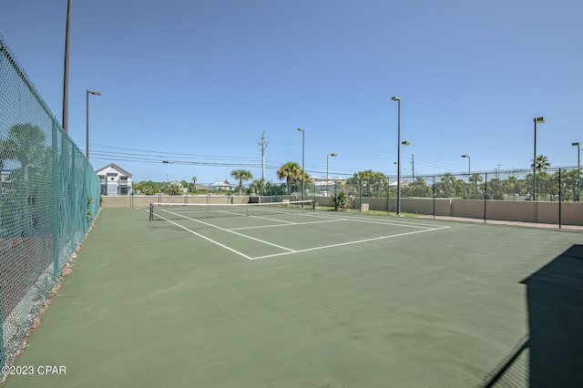 view of tennis court featuring basketball court