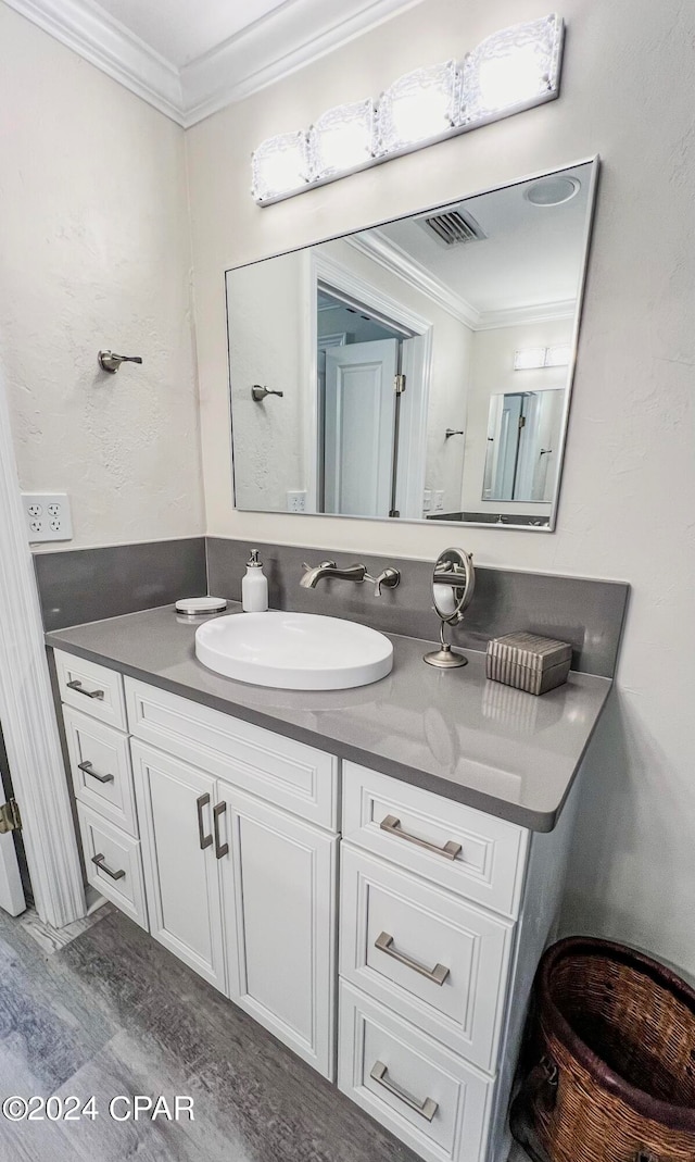 bathroom featuring vanity and ornamental molding