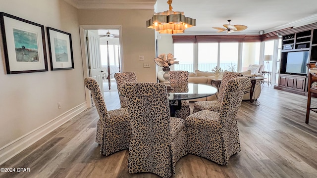 dining space with hardwood / wood-style floors, ceiling fan, and ornamental molding