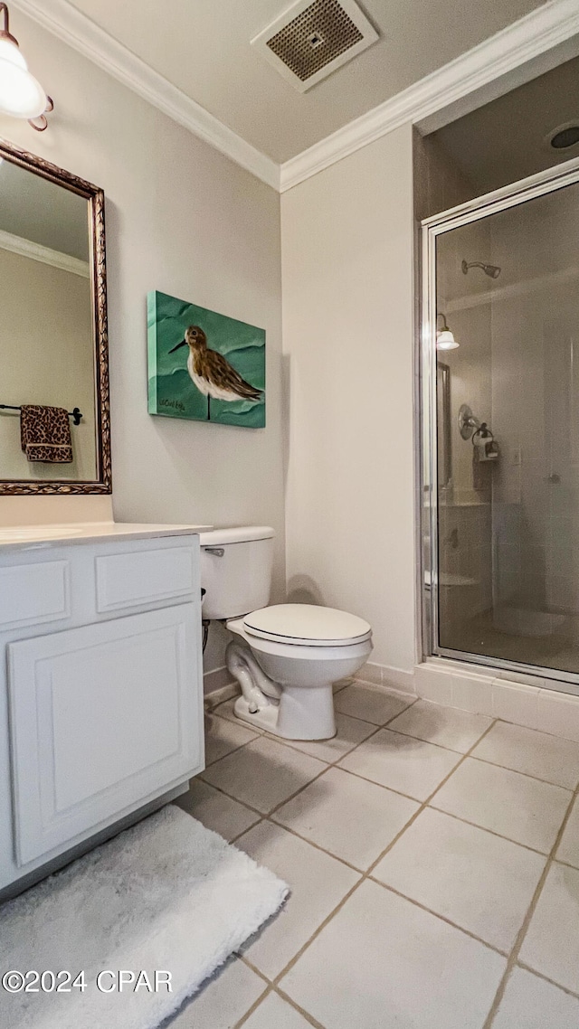 bathroom with ornamental molding, an enclosed shower, toilet, and vanity