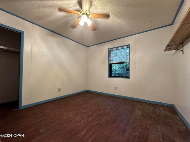 unfurnished bedroom with dark hardwood / wood-style flooring, ceiling fan, and a textured ceiling