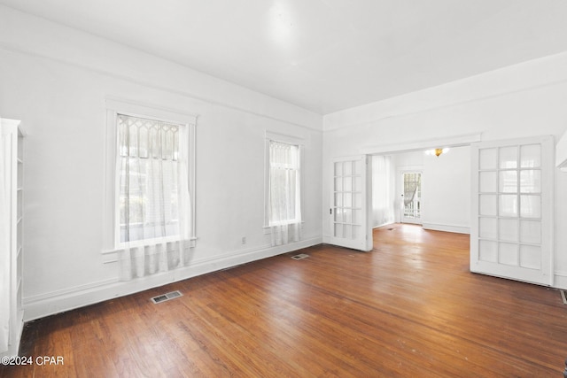 unfurnished room with wood-type flooring and french doors