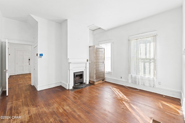 unfurnished living room with dark hardwood / wood-style flooring