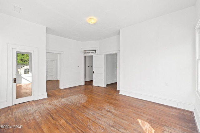 unfurnished room with hardwood / wood-style flooring