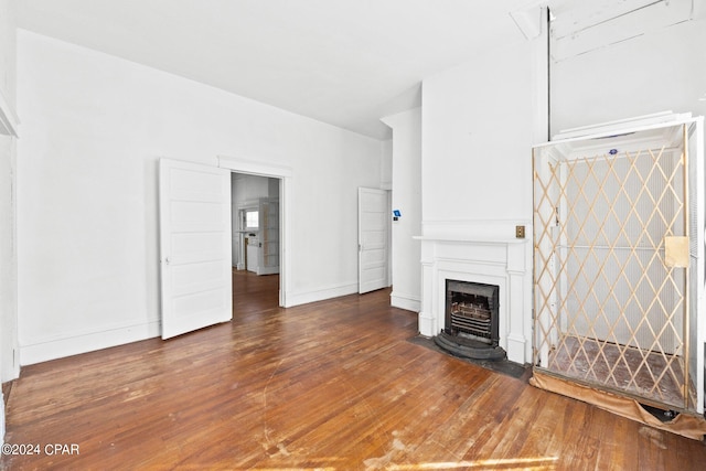 unfurnished living room featuring dark wood-type flooring