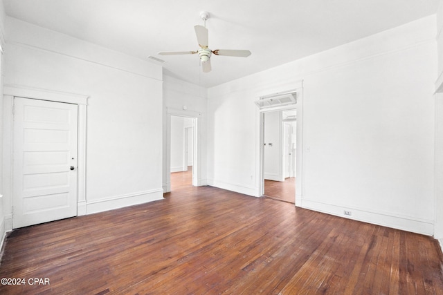 empty room with ceiling fan and dark wood-type flooring