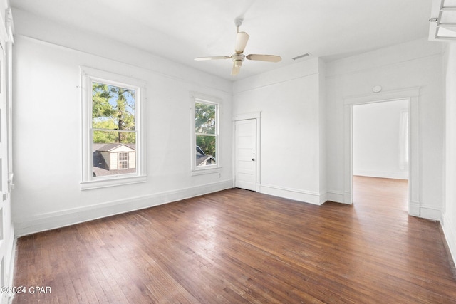 empty room featuring ceiling fan and dark hardwood / wood-style floors