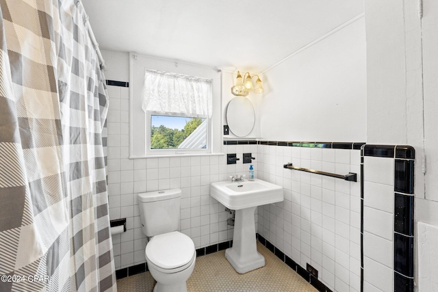 bathroom with tile walls, toilet, and tile floors