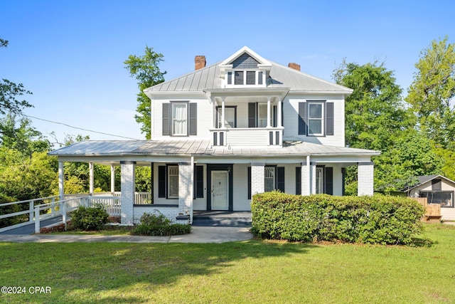 view of front of house featuring covered porch and a front yard