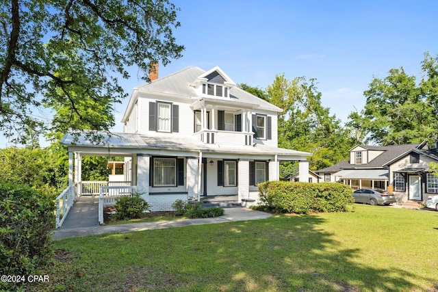 view of front of home featuring a front yard and covered porch