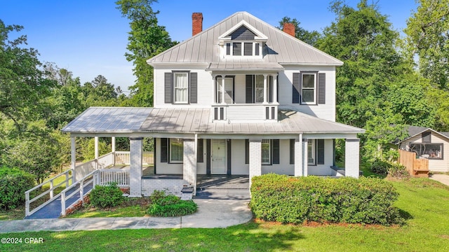 view of front of home with a porch and a front yard