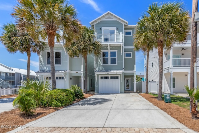 raised beach house featuring a garage and a balcony