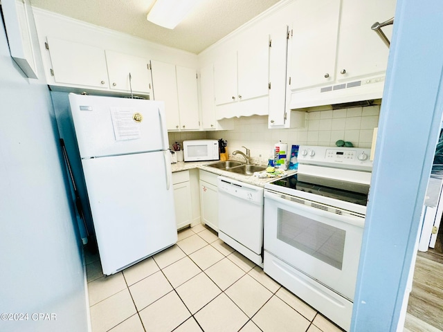 kitchen with sink, white appliances, backsplash, and white cabinetry