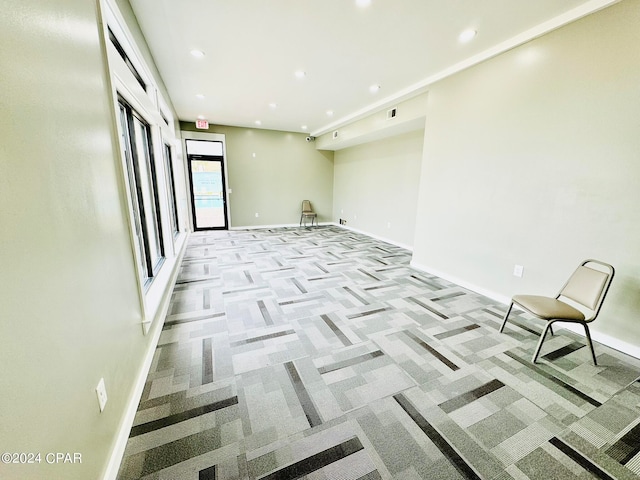 unfurnished room with light colored carpet