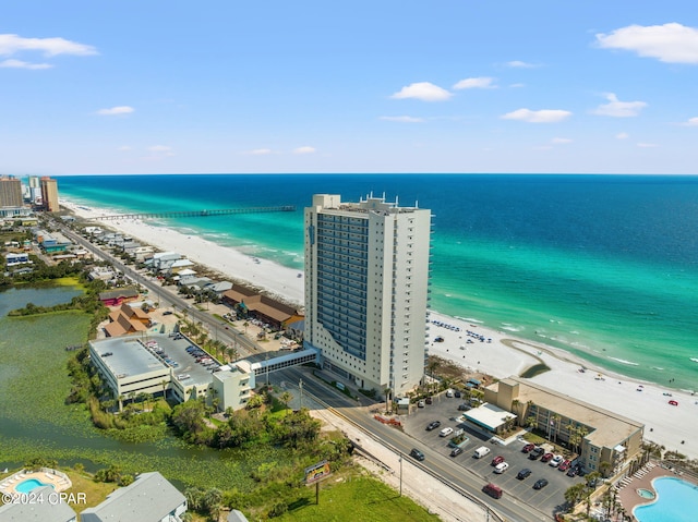 drone / aerial view with a water view and a beach view