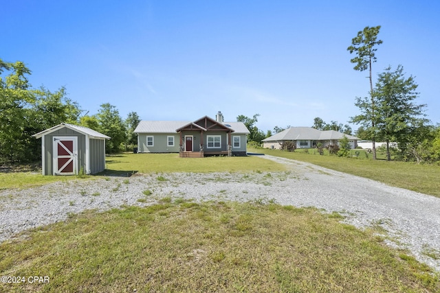 view of front of home featuring a storage shed and a front yard