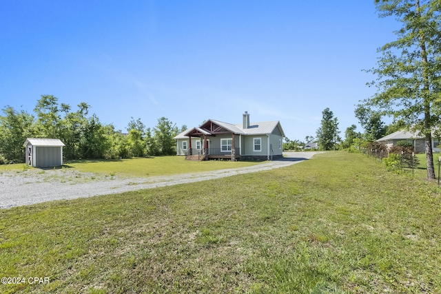 view of front of property with a front lawn and a shed