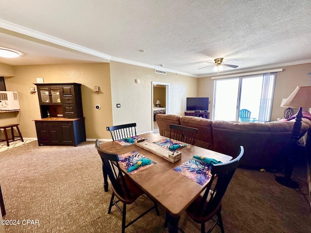 dining space featuring ornamental molding, carpet flooring, ceiling fan, and a textured ceiling