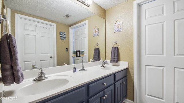 bathroom featuring vanity and a textured ceiling