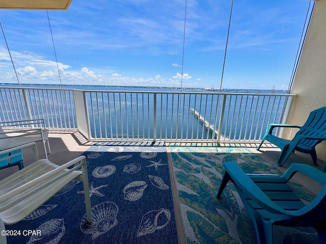 sunroom with a water view and a balcony