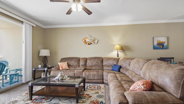 carpeted living room with ceiling fan and ornamental molding