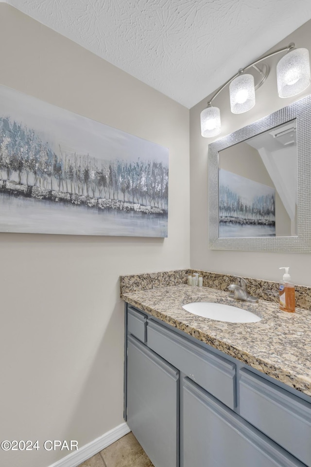 bathroom featuring tile patterned floors, vanity, and a textured ceiling