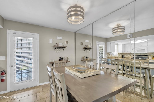 dining area with light tile patterned flooring