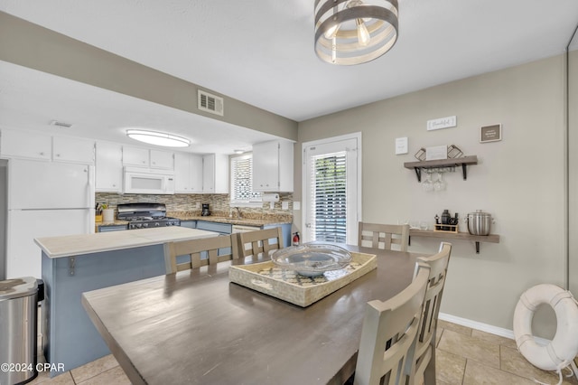 dining room featuring light tile patterned flooring