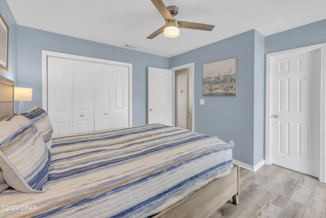 bedroom with light hardwood / wood-style flooring, a closet, and ceiling fan