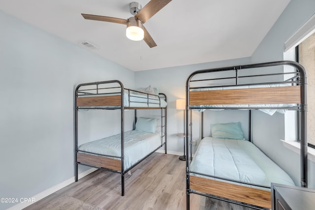 unfurnished bedroom with multiple windows, light hardwood / wood-style floors, and ceiling fan