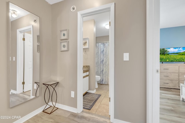 hallway with light hardwood / wood-style floors