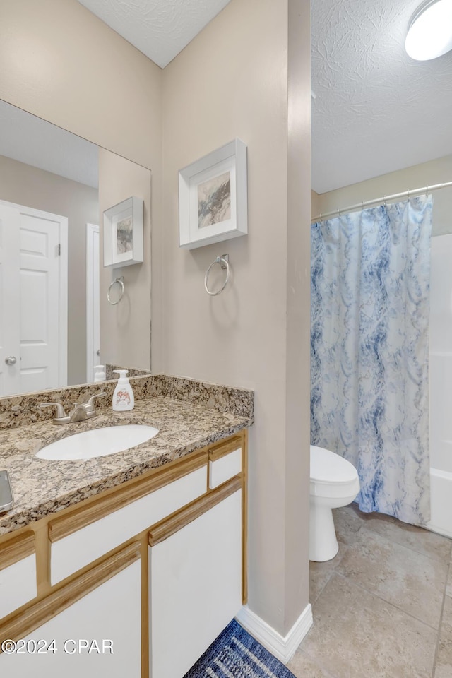 full bathroom with tile patterned floors, toilet, shower / tub combo, a textured ceiling, and vanity