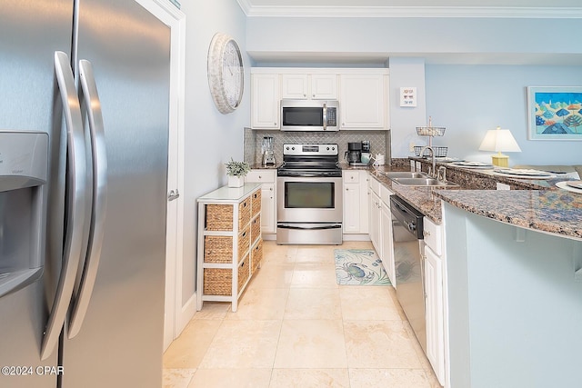 kitchen featuring appliances with stainless steel finishes, sink, light tile flooring, white cabinetry, and ornamental molding