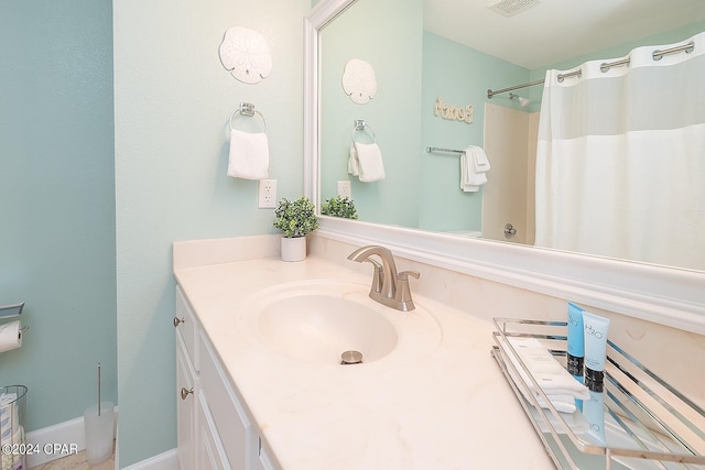 bathroom featuring vanity with extensive cabinet space