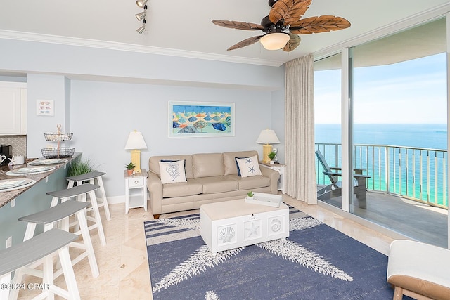 living room featuring ceiling fan, crown molding, a water view, and expansive windows