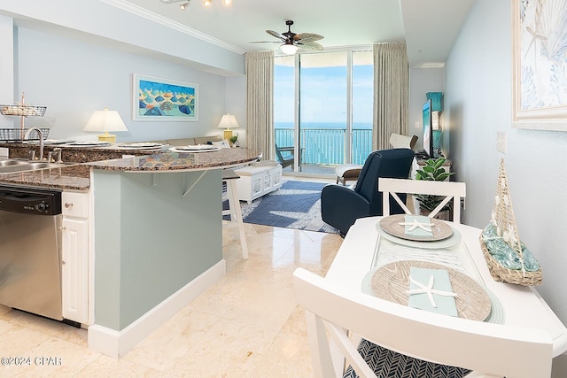 kitchen with white cabinets, a water view, floor to ceiling windows, dishwasher, and ceiling fan