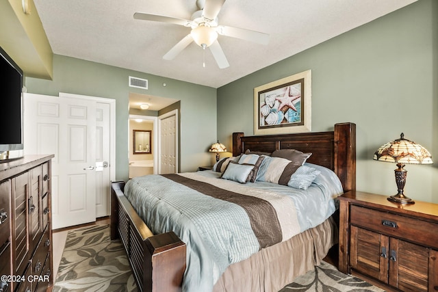 bedroom with a closet, ceiling fan, and ensuite bath