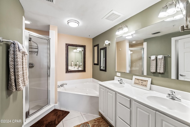 bathroom featuring double vanity, tile flooring, and plus walk in shower