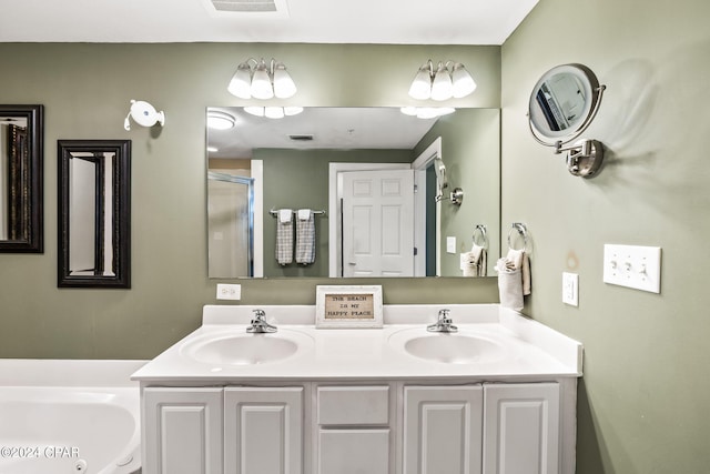 bathroom with dual bowl vanity and a bath