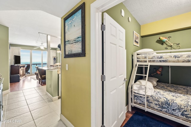 bedroom featuring tile flooring and a textured ceiling