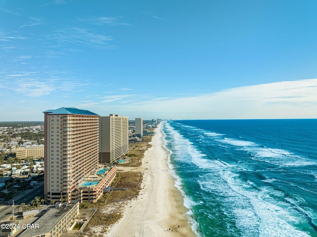 birds eye view of property featuring a water view and a beach view